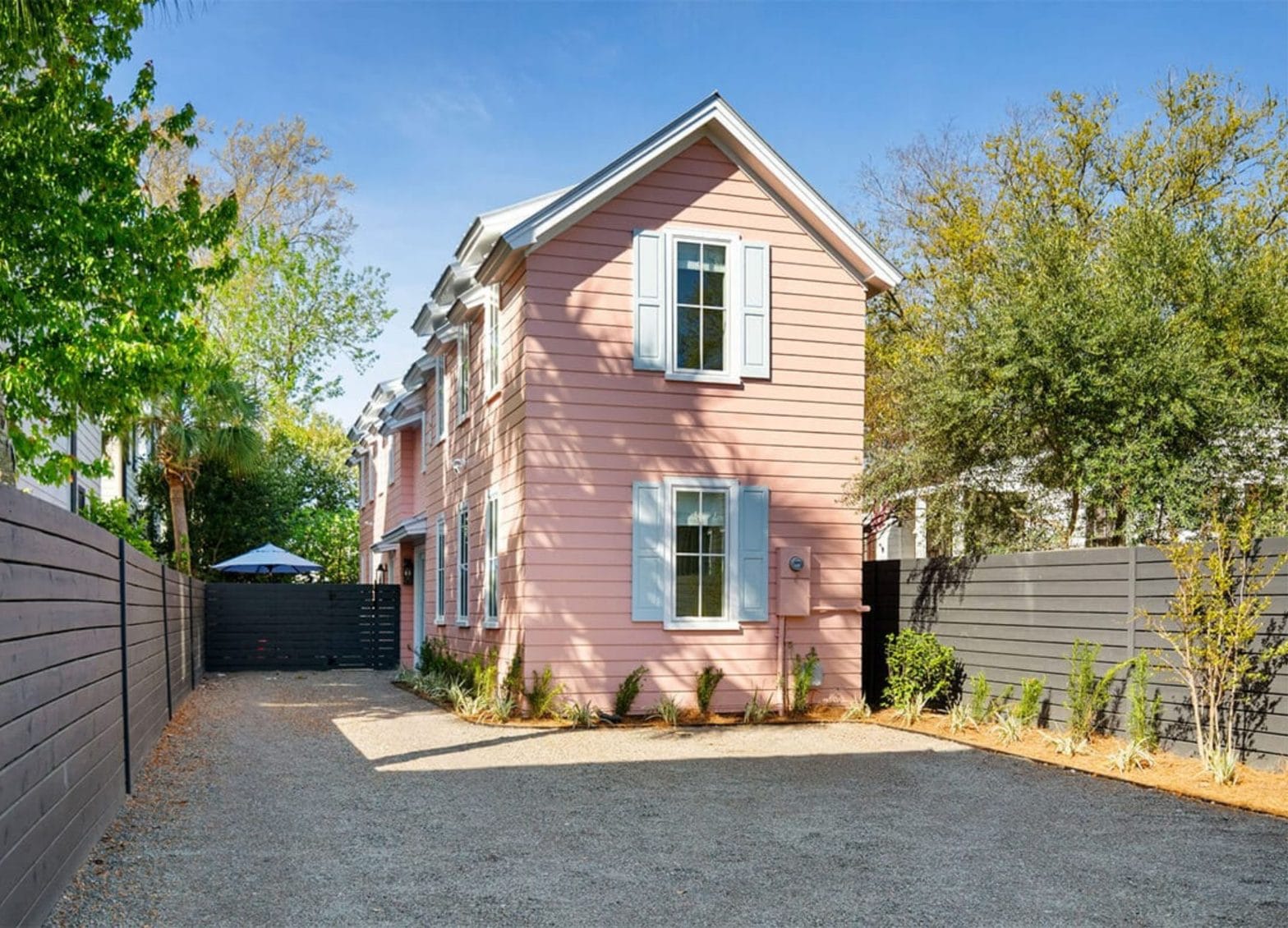Custom Charleston home exterior with shutters and landscaped yard